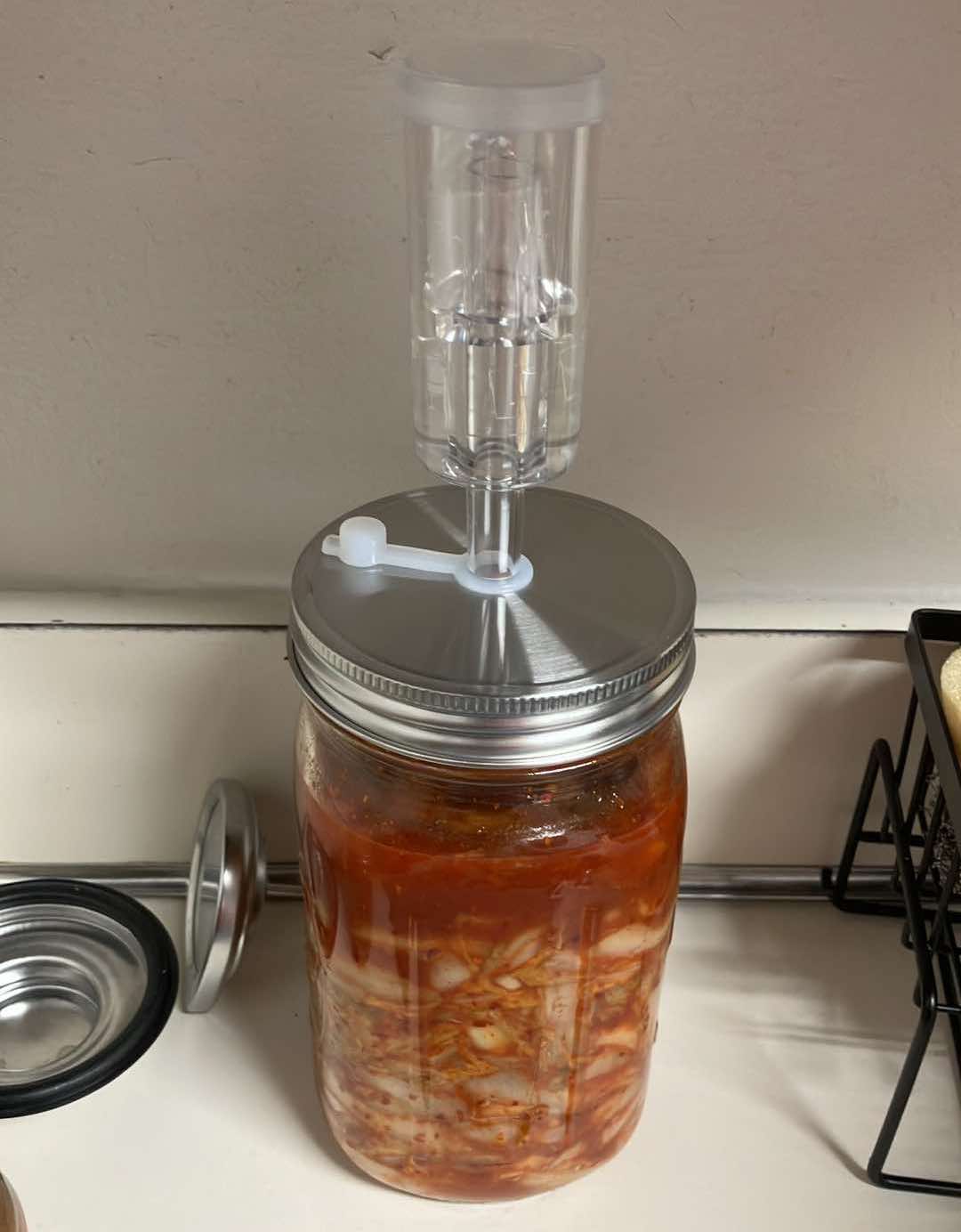 Jar of kimchi with airlock in lid